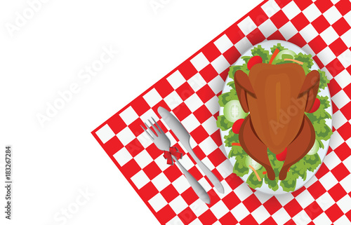 Roasted turkey bird on oval plate with fork and knife on red tablecloth.