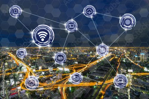 Wireless communication connecting of smart city Internet of Things Technology over the Expressways with bangkok cityscape at twilight time background, technology business IOT concept