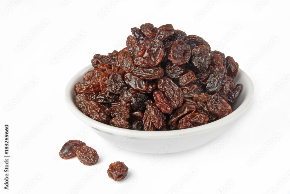 Fototapeta premium Black raisins on a white background 