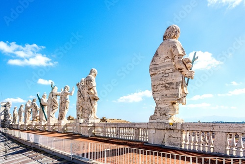 Back view of the sculptures of the twelve saints at the top of St. Peter's basilica in Vatican. photo