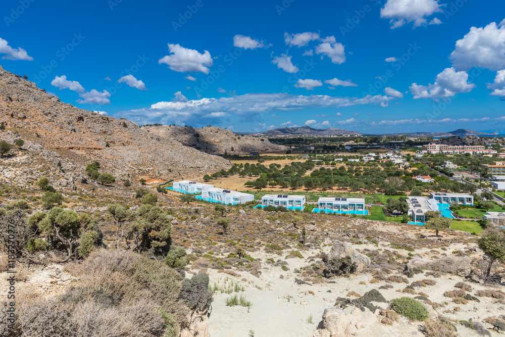 Stony landscape of Tsambika mountain and a view of Kolymbia, a small resort on the Rhodes Island, Greece.