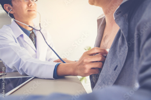 doctor use stethoscope to listening to patient heartbeat in clinic