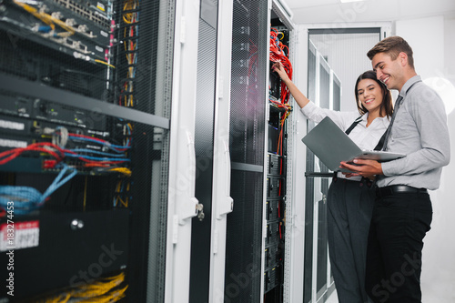 Team of technicians working together on servers at the data centre