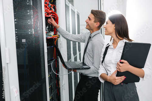 Team of technicians working together on servers at the data centre