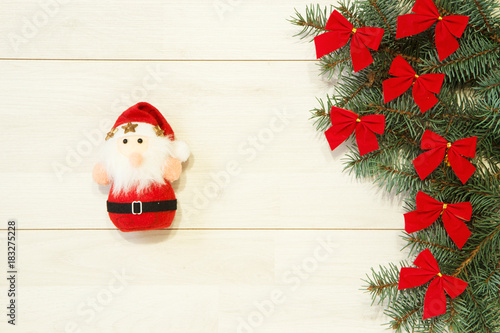 Wallpaper Mural New Year / Christmas tree with red bows, Santa toy on the wooden background template Torontodigital.ca