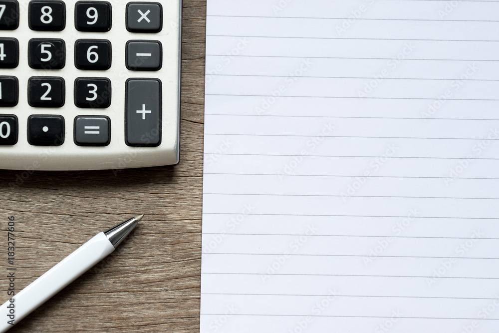 Blank note book with pen and calculator on wood background Blank note book with pen and calculator on wood background