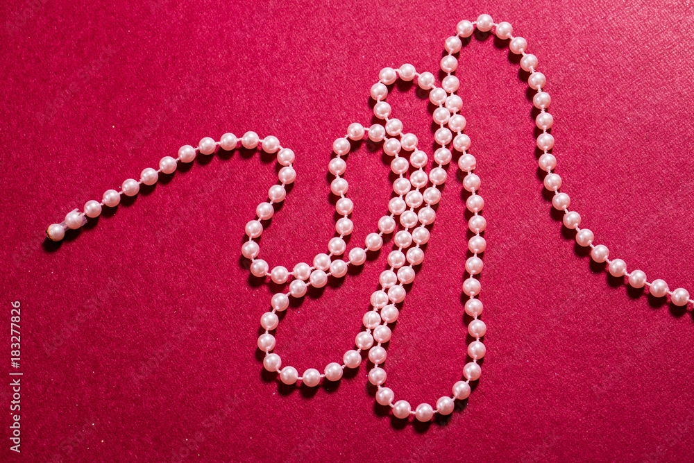 Pink Beads on Red Background Pink Beads on Red Background