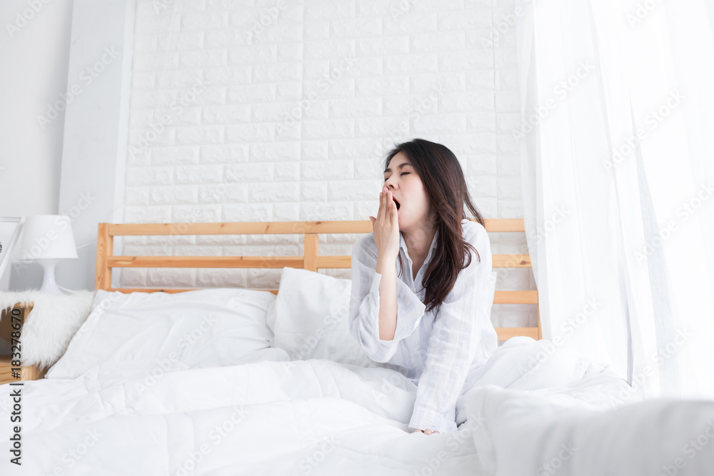 Young beautiful woman waking up early in the morning and annoyed alarm , Lazy girl in the bedroom. Young beautiful woman waking up early in the morning and annoyed alarm , Lazy girl in the bedroom.