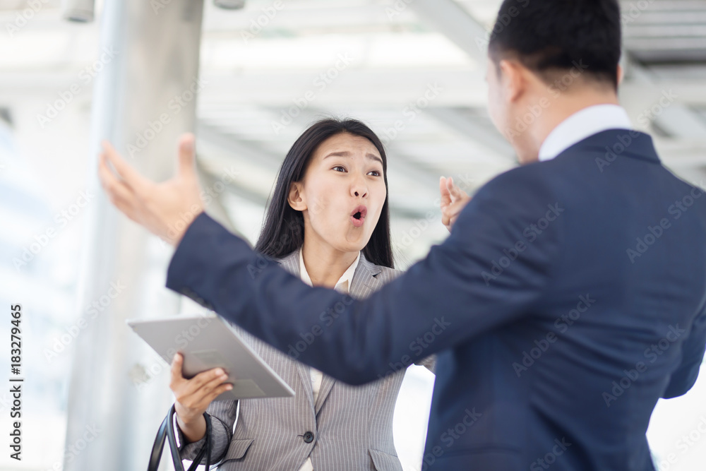 Young businesswoman holding papers talking with a businessman with anger, Boss found a mistake in documentation. Work failure concept. Young businesswoman holding papers talking with a businessman with anger, Boss found a mistake in documentation. Work failure concept.