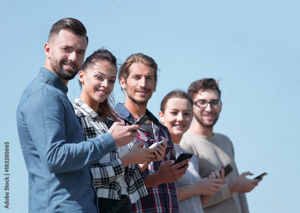 group of young people with modern smartphones. group of young people with modern smartphones.