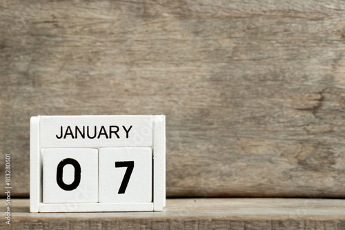 White block calendar present date 7 and month January on wood background