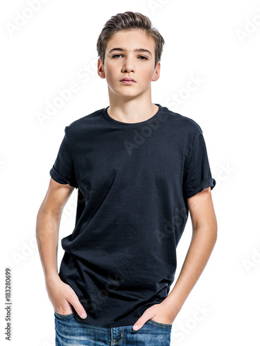 Photo of teenage handsome guy posing at studio