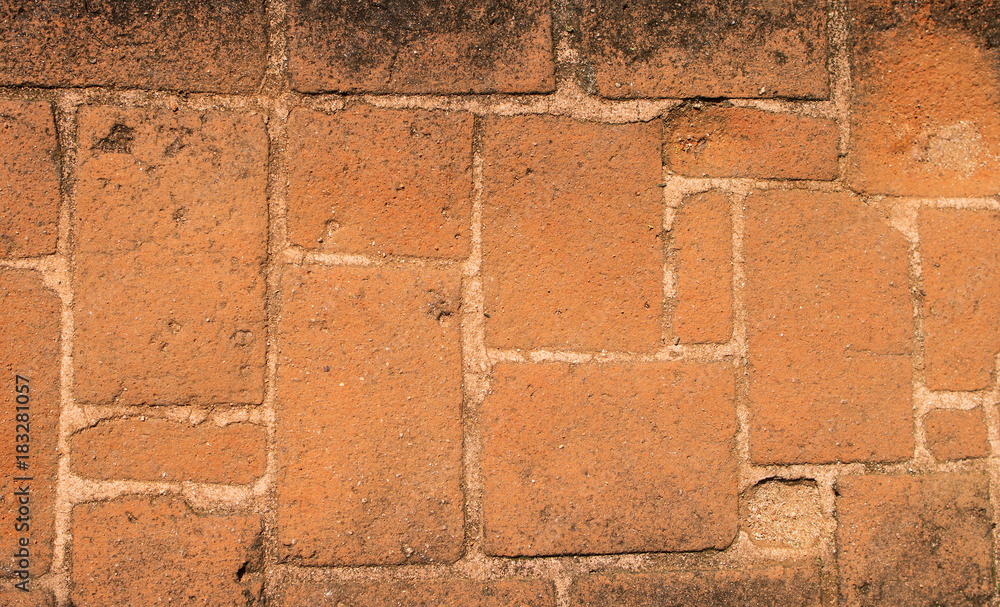 The background image of the surface of base of an ancient building made of a red brick. The background image of the surface of base of an ancient building made of a red brick.
