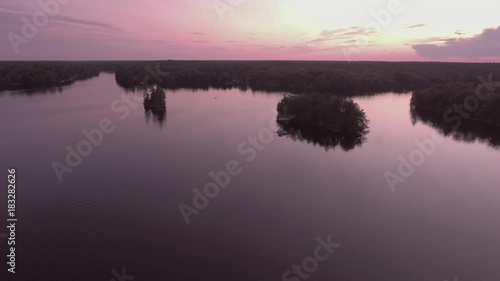 Flying from high point of view to meet pontoon boat heading home on the water at sunset on lake McKellar
UNGRADED DLOG FOOTAGE photo