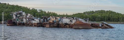 An old wrecked ship in the bay ,on the shore.