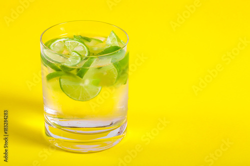 Glass with Water on Yellow Background
