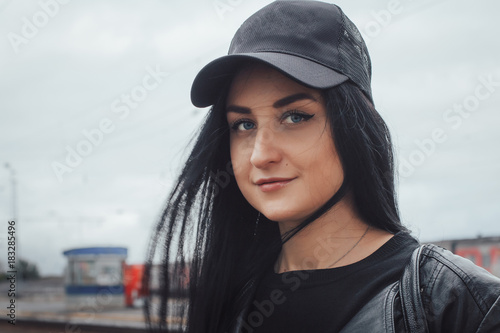 Beautiful brunette girl in black cap photo