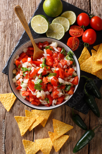 Billede på lærred Homemade spicy pico de gallo close-up in a bowl and nachos