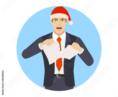 Businessman in Santa hat tearing paper