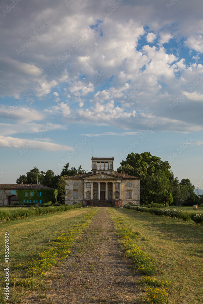 Ancient Italian Neoclassical House inside Park and Blue Sky with Clouds Ancient Italian Neoclassical House inside Park and Blue Sky with Clouds