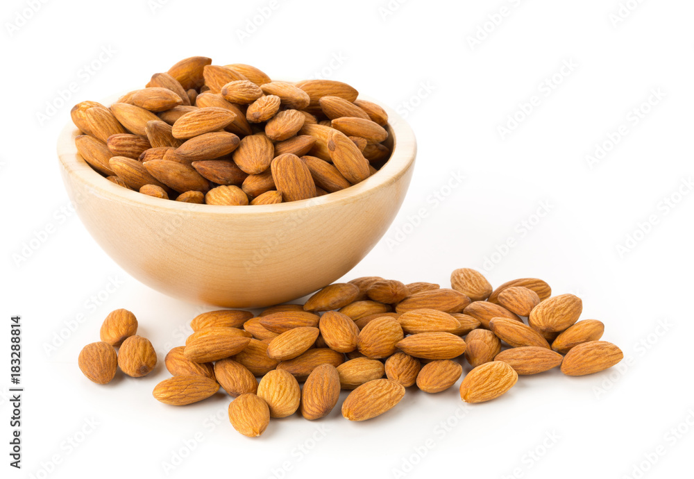 Heap of shelled almond kernels in wooden bowl Heap of shelled almond kernels in wooden bowl