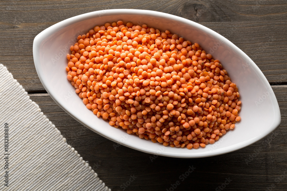Raw red, dried lentils in white bowl Raw red, dried lentils in white bowl