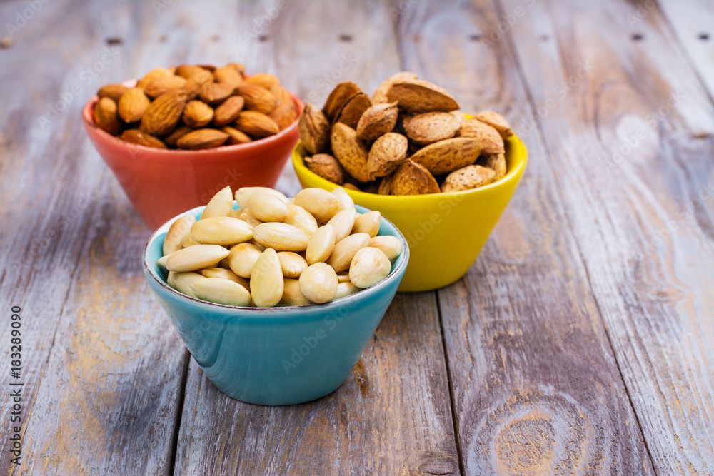 Assortment of almond nuts - peeled and fried, unpeeled and almonds in shells Assortment of almond nuts - peeled and fried, unpeeled and almonds in shells