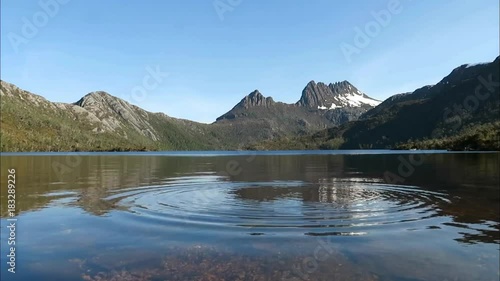 Ripples circle outwards in mountain lake, Tasmania.
