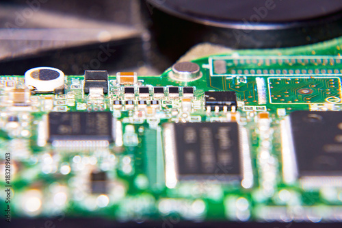Parts of the computer. The electronic circuit Board of the computer. Circuit Board hard drive. Selective focus