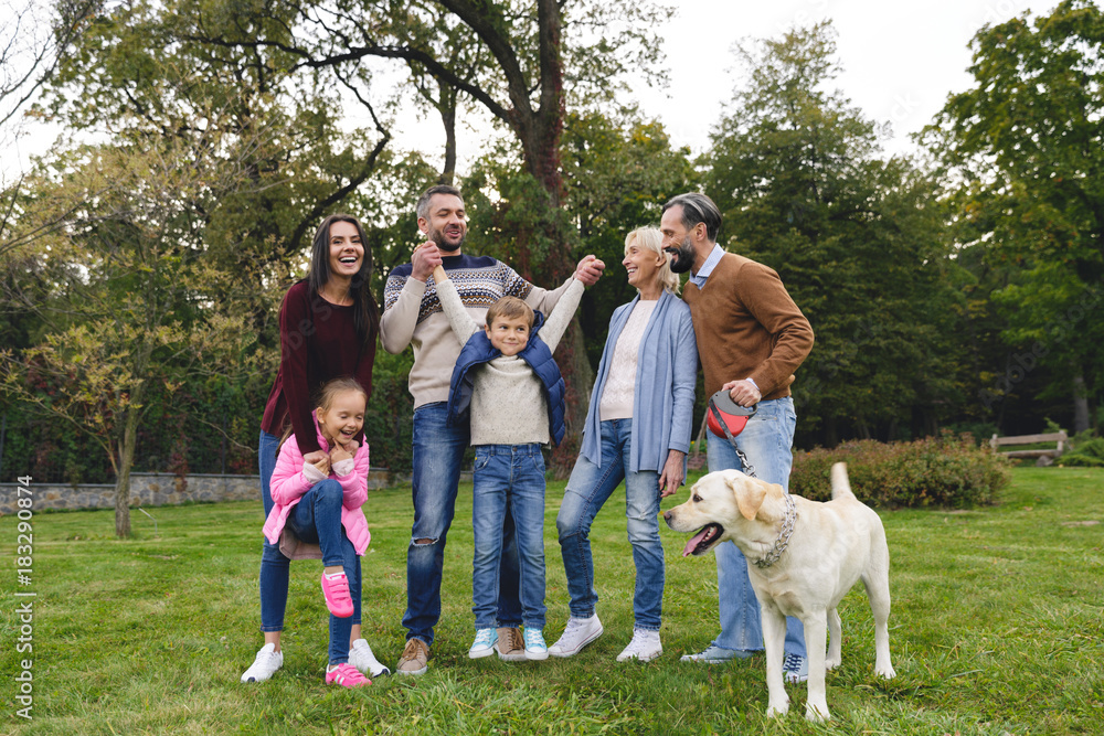 Obraz premium Happy big family with labrador retriever dog spending time