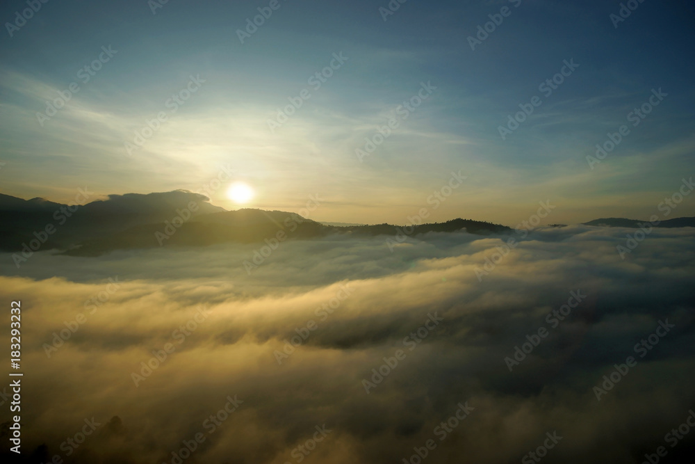 sea fog over the hills with sunrise background