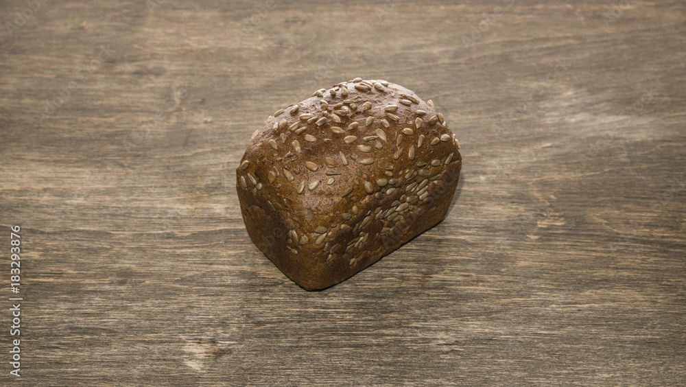 Naklejka premium Bread on a wooden background