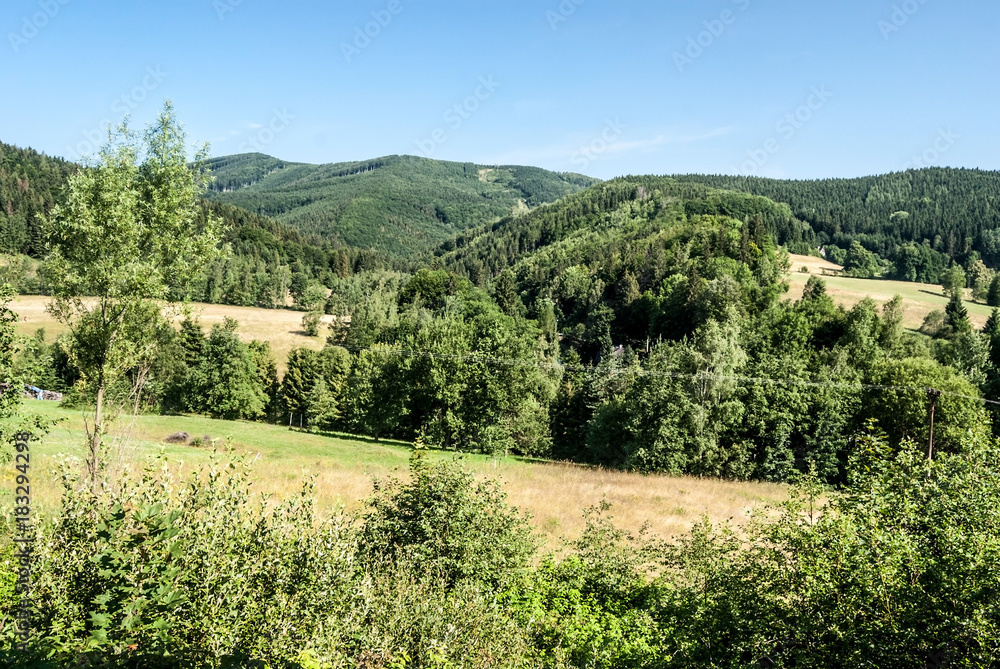 nice landscape with meadows, hills, forest and clear sky near Horni Lipova in Czech republic