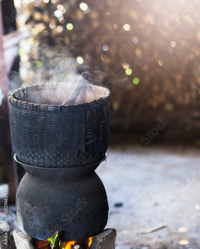 Cooked rice on charcoal stove, Thai traditional cooking,Thai lifestyle. photo