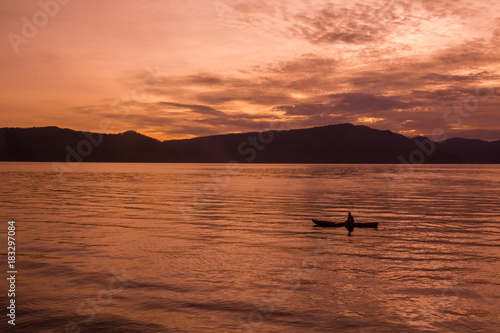 Sunrise Sunrise with reflections at Lake Toba, Samosir Island, Indonesia.