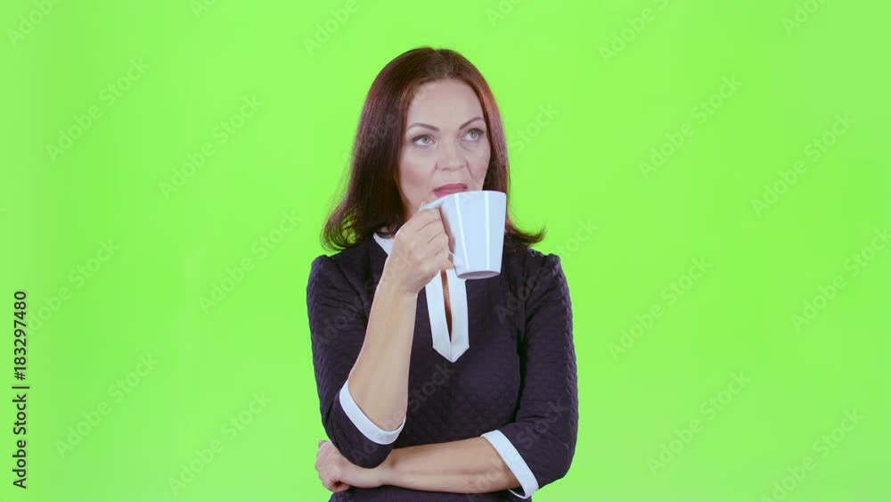Woman with a mug of tea looks into the distance and thinks about her own affairs. Green screen