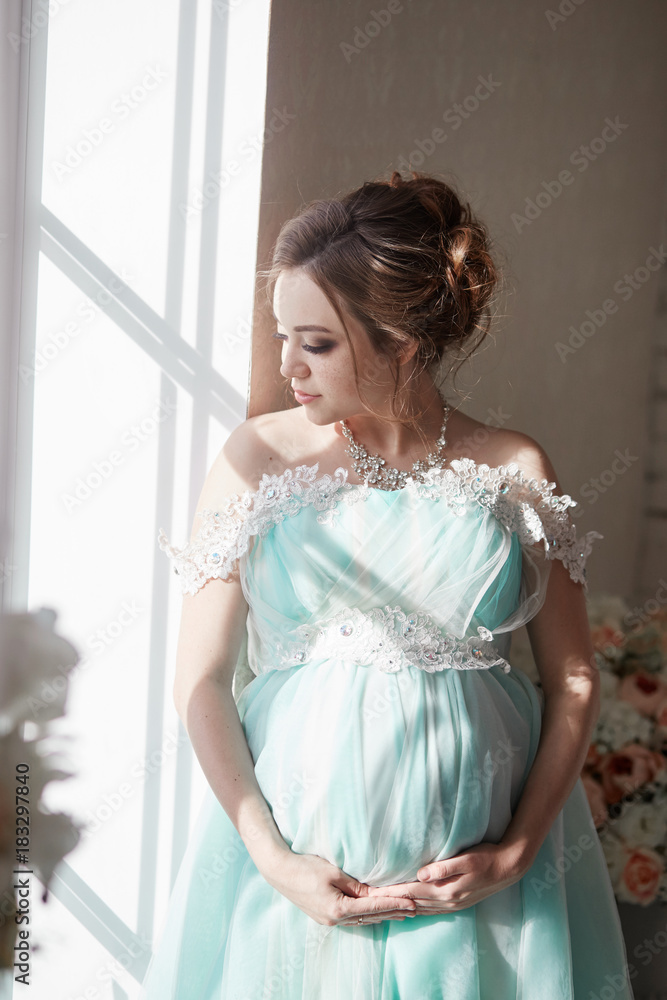 Pregnancy, pregnant woman, family planning, caesarean section delivery, waiting for delivery. Depression and vitamins for healthy growth. A woman in a long luxurious dress Pregnancy, pregnant woman, family planning, caesarean section delivery, waiting for delivery. Depression and vitamins for healthy growth. A woman in a long luxurious dress