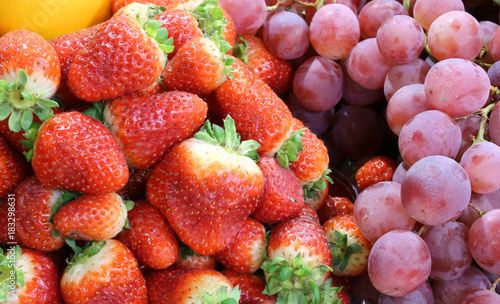 red strawberries and bunches of grapes two very expensive firstf photo