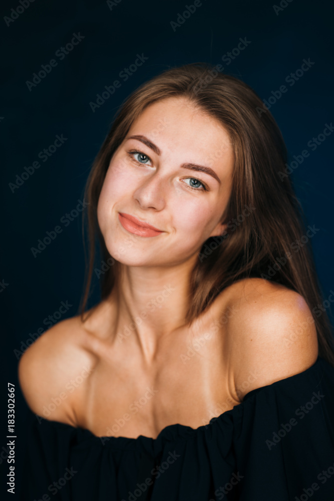 Portrait beautiful girl on a dark studio background Portrait beautiful girl on a dark studio background