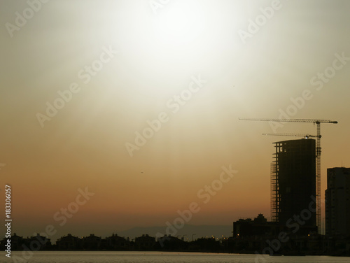 Construction crane and building at sunset