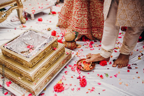 Fire burns before bride and groom during the traditional Saptapadi wedding ceremony photo