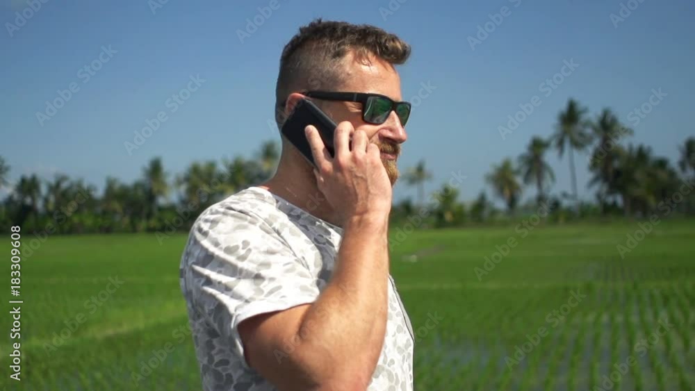 Happy man talking on cellphone and walking in country, super slow motion 120fps
Happy man talking on cellphone and walking in country, super slow motion 120fps