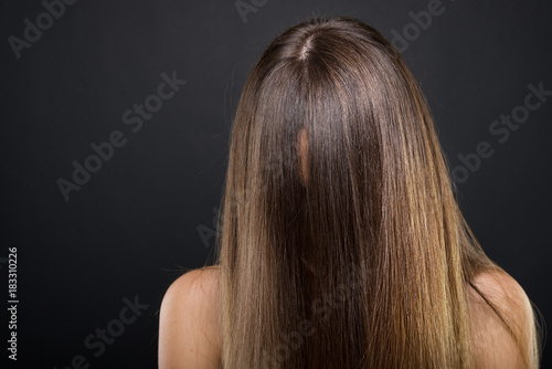 Brunette woman with long hair covering her face