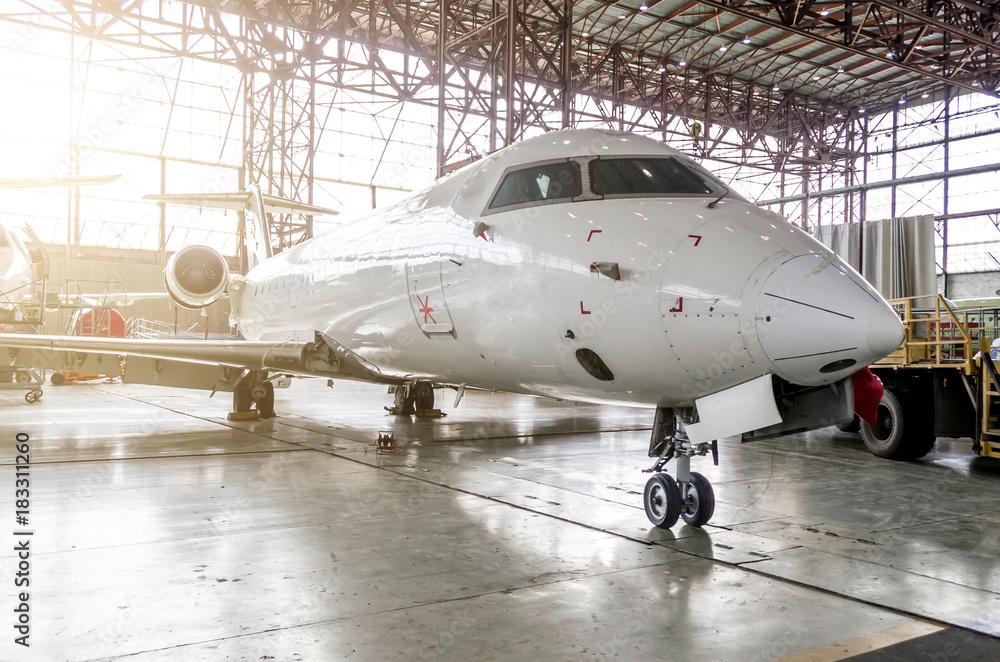 Passenger aircraft in the hangar on service. Passenger aircraft in the hangar on service.