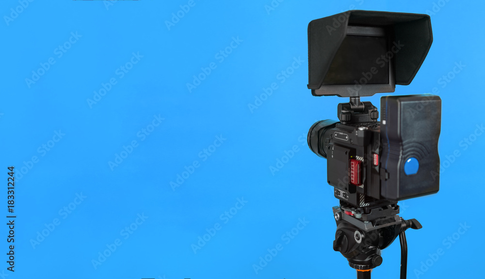 Professional video camera on vivid color background making contrast Professional video camera on vivid color background making contrast