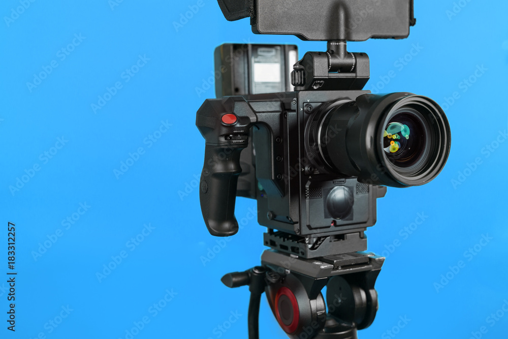 Professional video camera on vivid color background making contrast