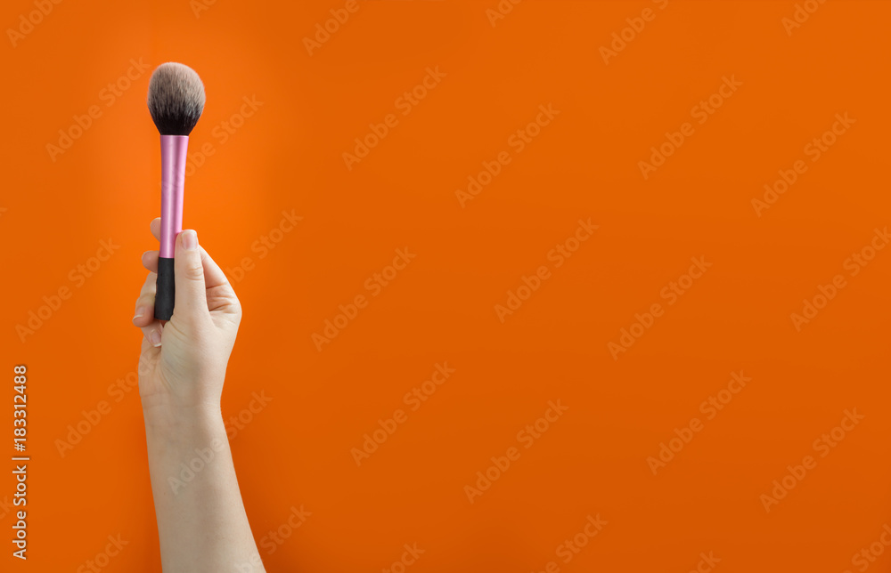 Set of makeup brushes on orange background. Set of makeup brushes on orange background.