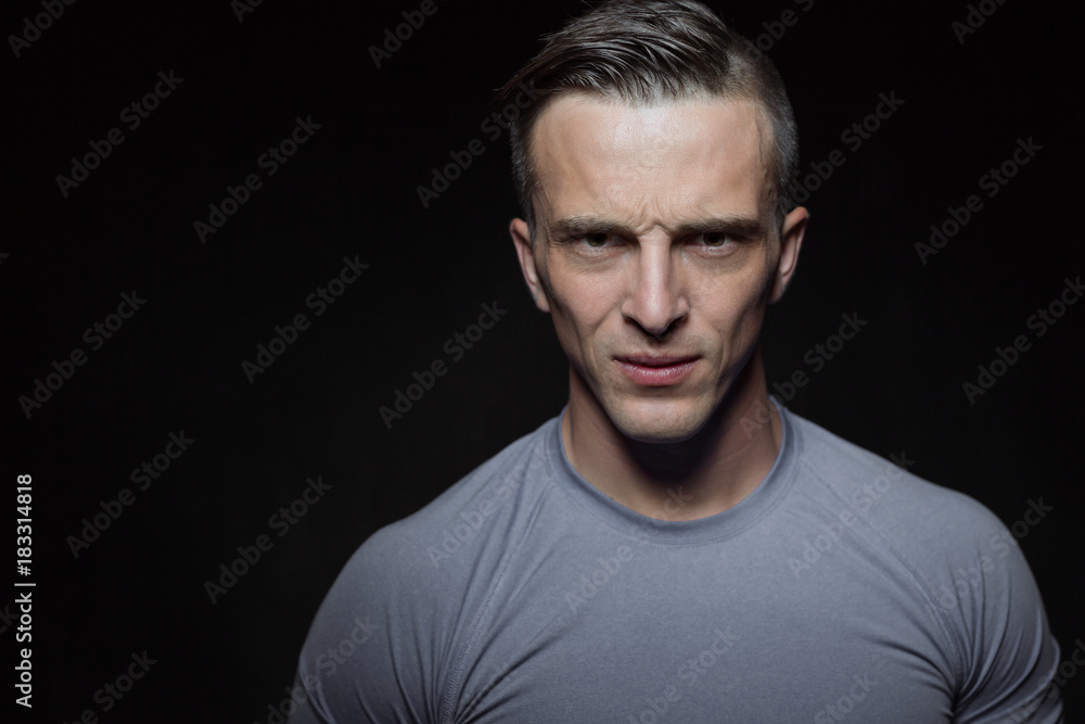 Portrait of bodybuilder shoor in studio on black background