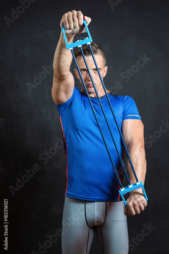 Portrait of a handsome athletic man with perfect muscular body over black background. Bodybuilding concept. Healthy lifestyle.