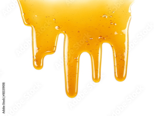 Honey dripping isolated on white background